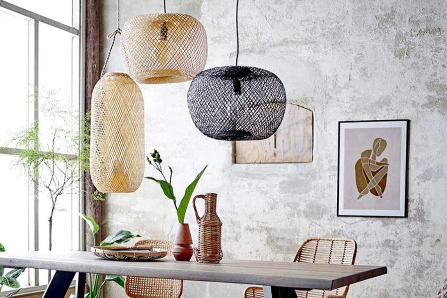 Rodi Hängeleuchte von Bloomingville aus naturfarbenem Bambusgeflecht, Ø 42 cm, H 30 cm, aufgehängt über einem Esstisch in einem skandinavisch eingerichteten Wohnzimmer.