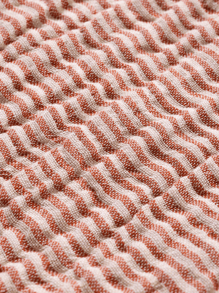 Verleihen Sie Ihrem Schlafzimmer mit dem Fino Bettüberwurf von Ferm Living einen Hauch von Eleganz und Komfort. Hergestellt aus nachhaltiger Baumwolle, bietet er Wärme und Stil.