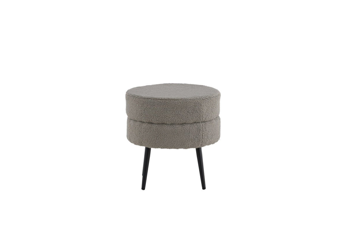 Runder Pouf Pot in Grau mit Teddystoff-Bezug, Durchmesser 40 cm, auf schwarzen, leicht ausgestellten Stahlbeinen stehend.