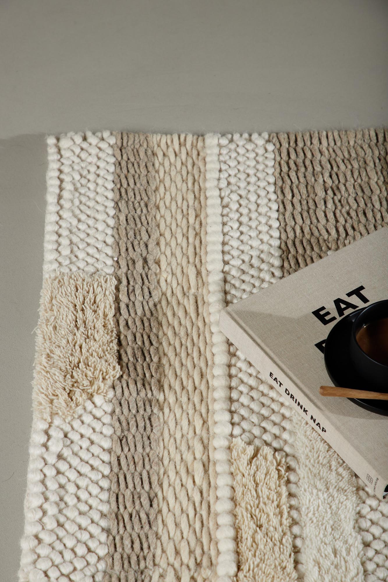 Entdecken Sie den Sixten Teppich von Venture Home: 200x70 cm, aus edler Wolle, mit modernem Muster in sanften Tönen – ideal für einladende Wohnräume.