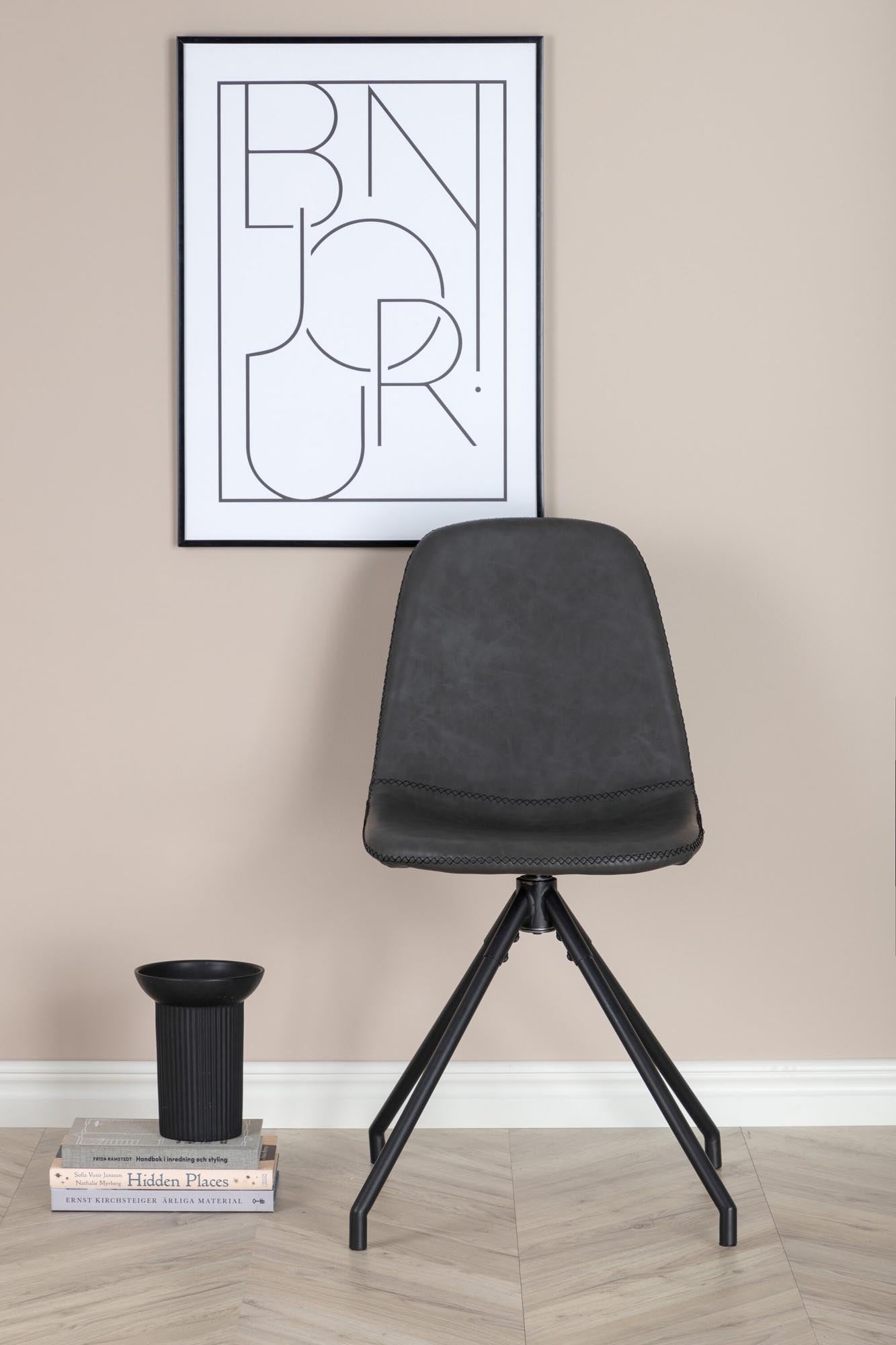 Der Polar Drehstuhl von Venture Home: Elegantes Design, drehbar, schwarzes Kunstleder, stabiler Metallrahmen, ideal für modernes Esszimmer.