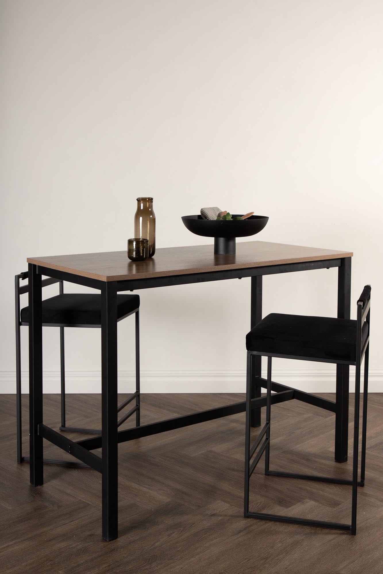 Der Camden Tisch von Venture Home: stilvolles Design, MDF in Walnuss, schwarzer Stahl, perfekt für Barhocker, modern und langlebig.