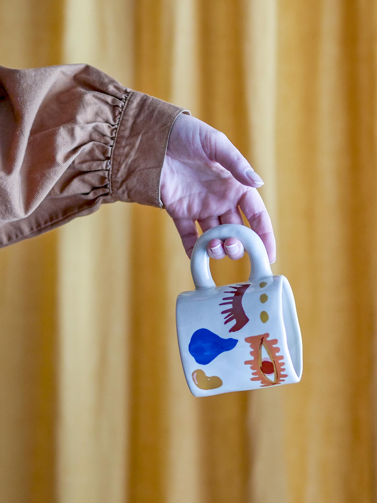 Die Horus Tasse in leuchtendem Orange vereint robustes Steingut mit stilvollem Design für den täglichen Genuss.