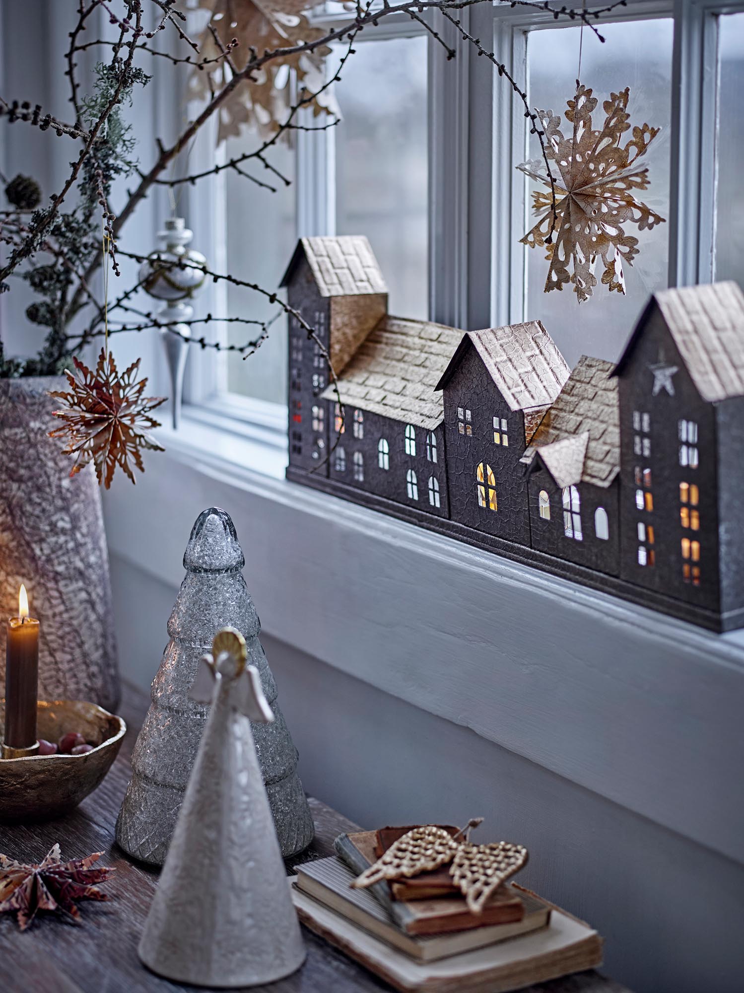 Eleganter goldener Teelichthalter aus Metall, inspiriert von Stadtlandschaften, für stimmungsvolle Beleuchtung.