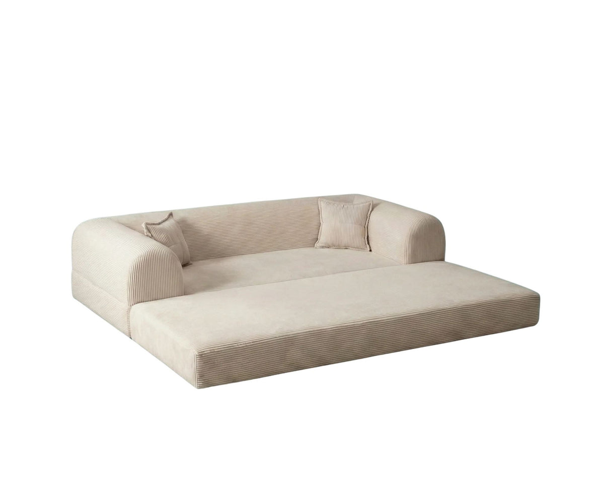 Cremefarbenes 3-Sitzer Schlafsofa Legom Eco von Hanah Home aus geripptem Cord-Plüschstoff mit zwei Kissen im Roll-Pack-Design abgebildet.