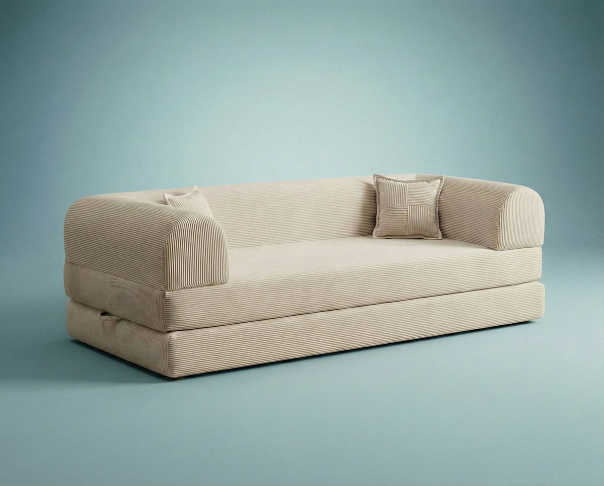 Cremefarbenes 3-Sitzer Schlafsofa Legom Eco von Hanah Home aus geripptem Cord-Plüschstoff mit zwei Kissen im Roll-Pack-Design abgebildet.