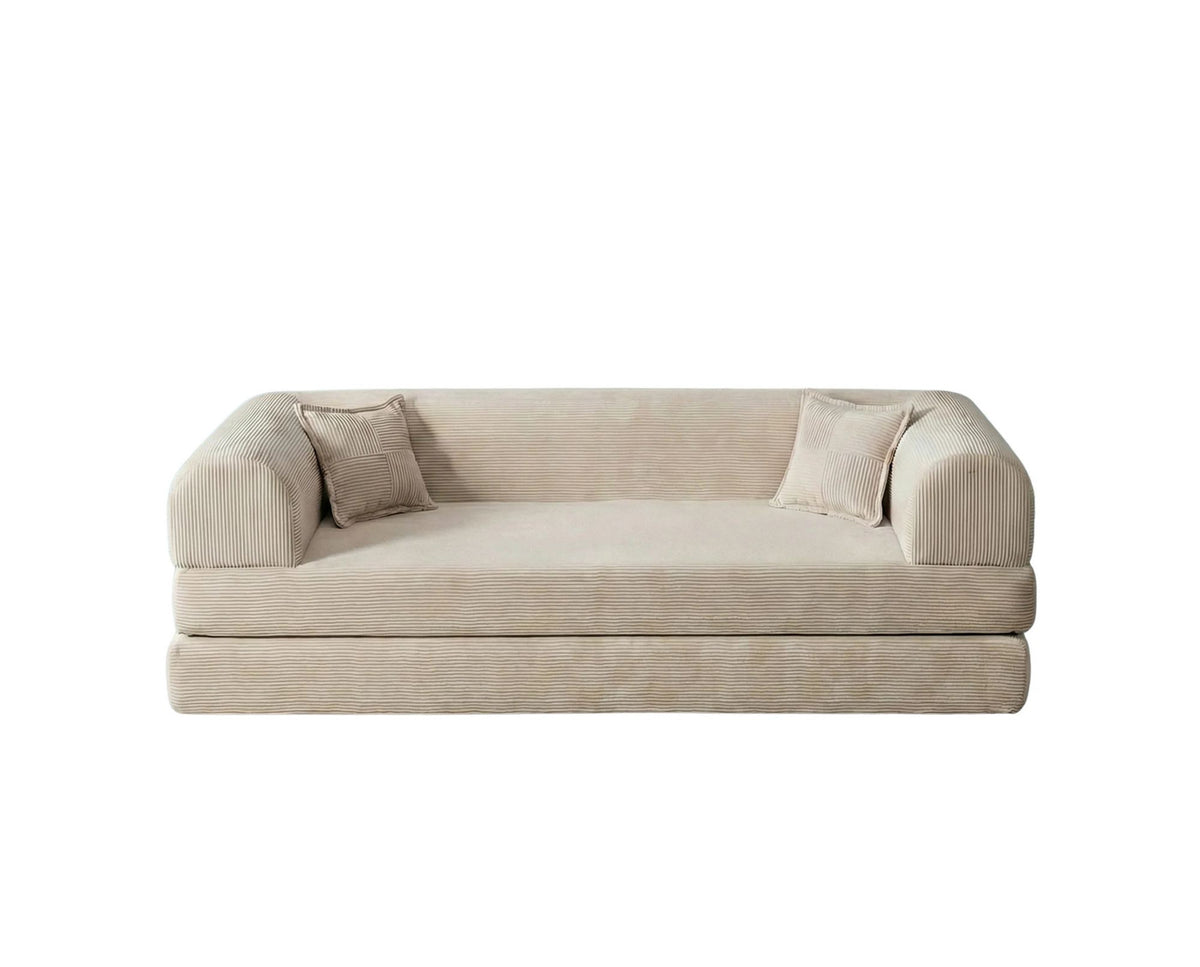 Cremefarbenes 3-Sitzer Schlafsofa Legom Eco von Hanah Home aus geripptem Cord-Plüschstoff mit zwei Kissen im Roll-Pack-Design abgebildet.