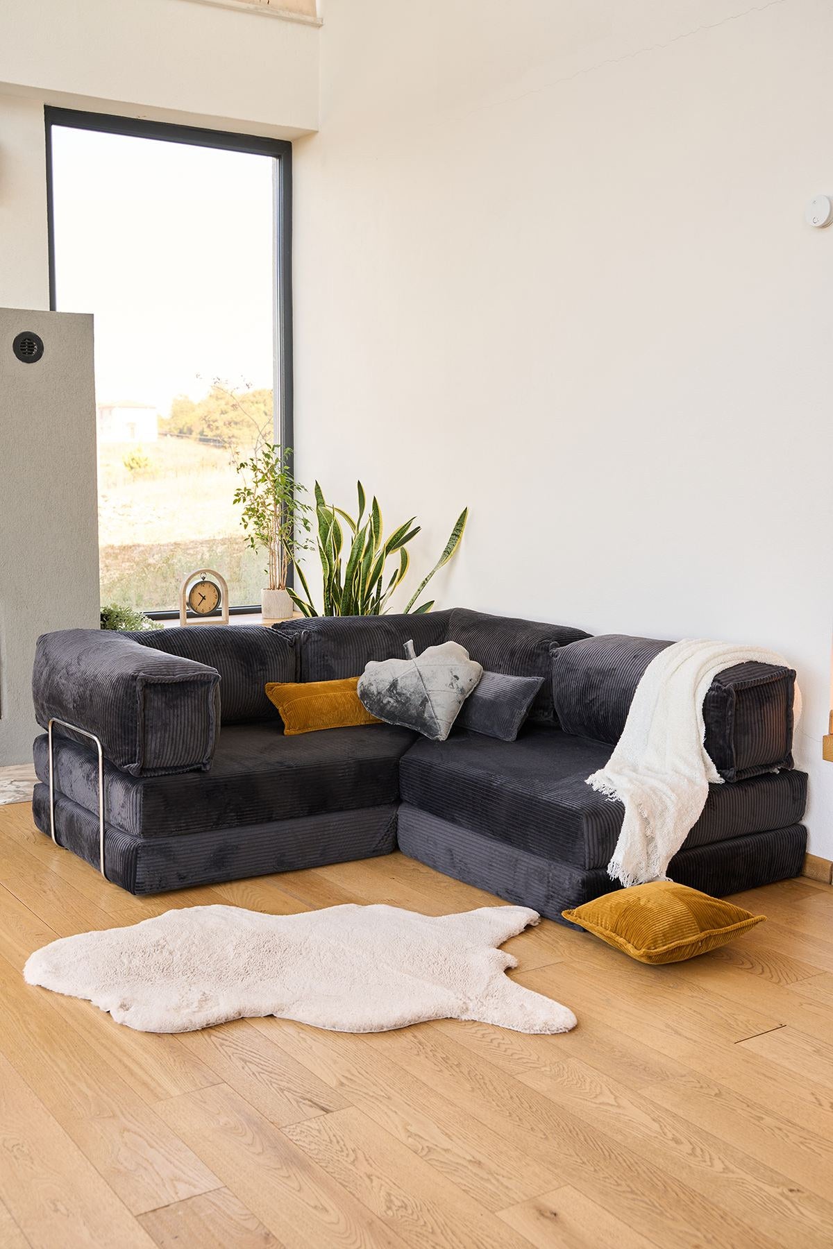 Braunes Eck-Schlafsofa aus Cord-Plüschstoff mit vier Kissen, rutschfester Sohle und abnehmbarem Bezug, Frontalansicht.