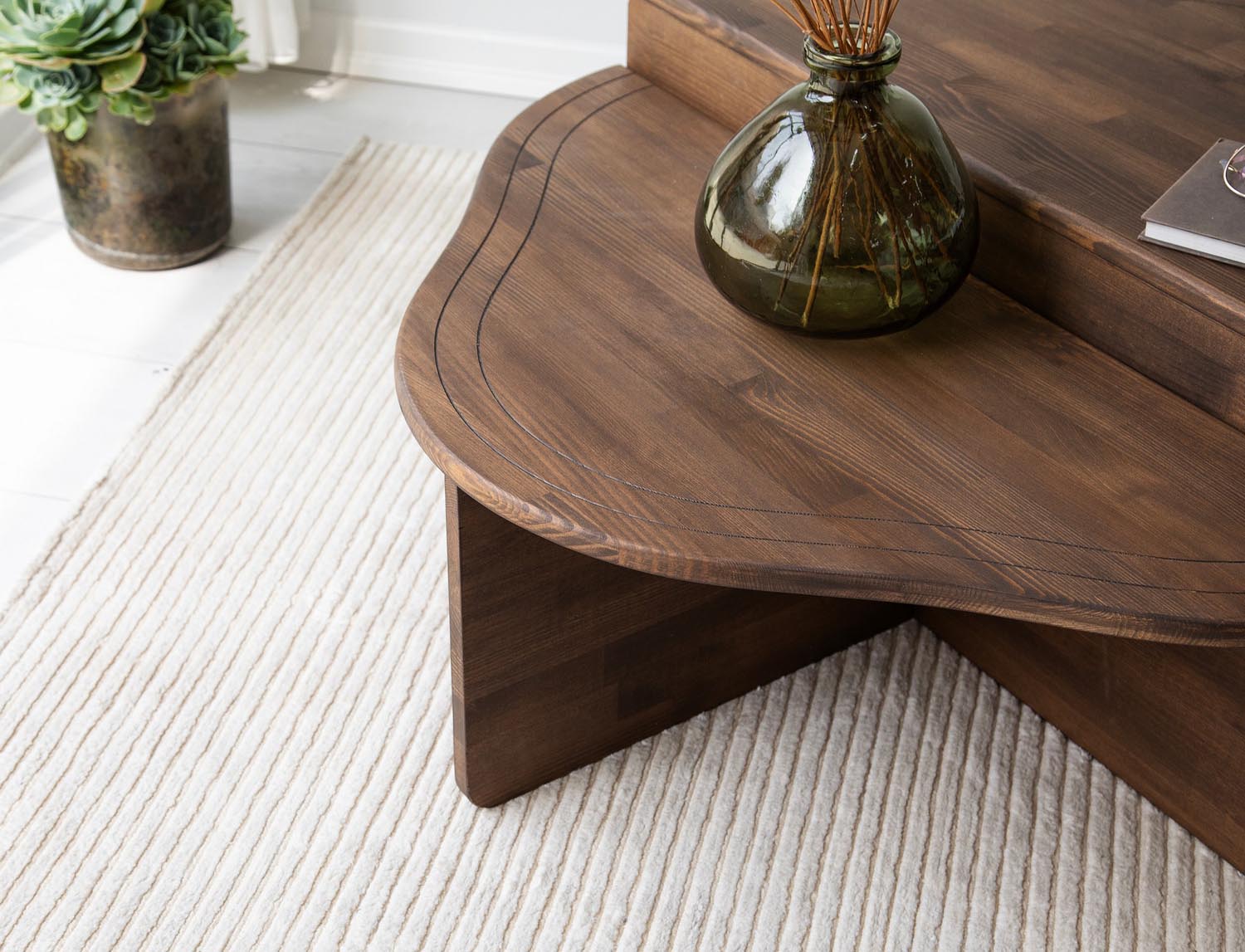 Erleben Sie den Altopiano Sofatisch von Hanah Home in edler Walnussoptik – ein stilvoller, langlebiger Tisch aus massivem Kiefernholz, der Ihr Zuhause bereichert.