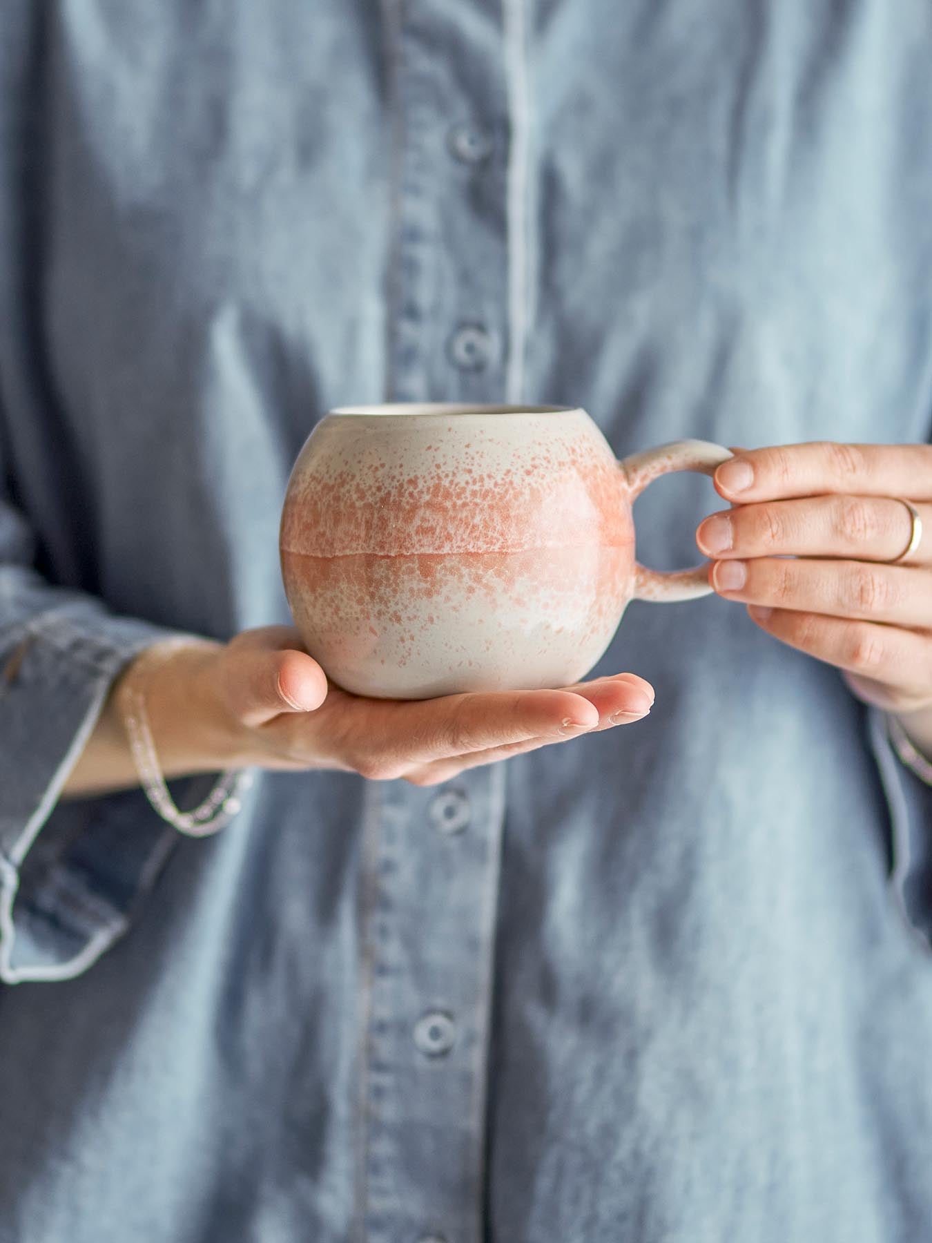 Genießen Sie stilvolle Momente mit dem Paula Becher von Bloomingville. Handgefertigt aus Steingut in lebhaftem Orange, ein Unikat für jeden Tag.