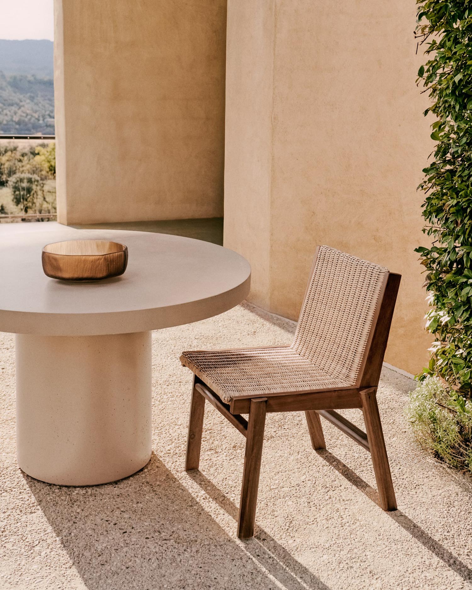 Stilvoller Stuhl aus FSC-zertifiziertem Teakholz und synthetischem Rattan, perfekt für moderne Innen- und Aussenräume.