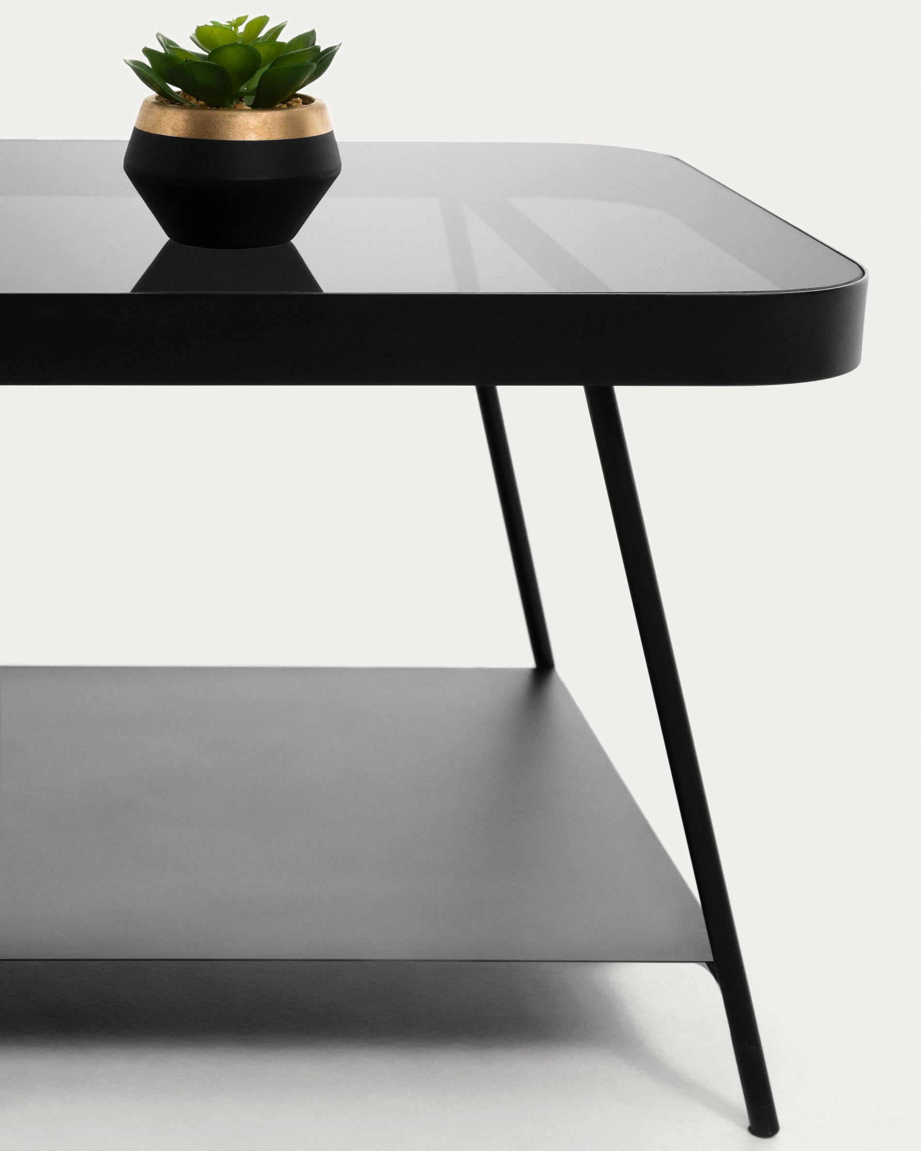 Eleganter Couchtisch mit raffinierter rauchgrauer Glasplatte und stabiler Stahlbasis in Schwarz, perfekt für stilvolle Wohnräume.