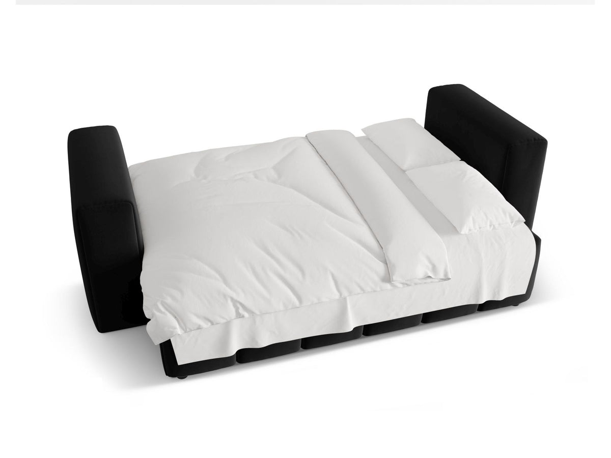 Sandfarbenes Samt-Bettsofa Verona mit drei Sitzplätzen, ausklappbarer Liegefläche, Bettkasten und schwarzen Kunststoffbeinen im Wohnraum.
