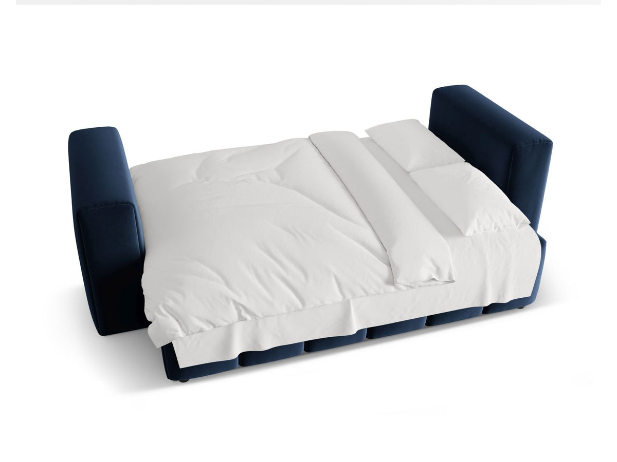 Sandfarbenes Samt-Bettsofa Verona mit drei Sitzplätzen, ausklappbarer Liegefläche, Bettkasten und schwarzen Kunststoffbeinen im Wohnraum.