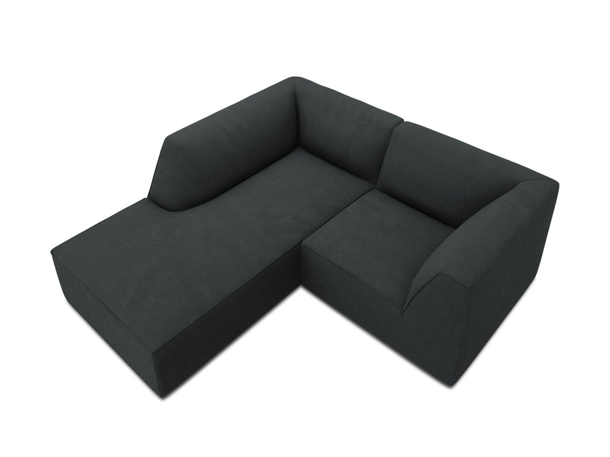 Modulares Ecksofa Siena mit gelbem Ottawa-Stoffbezug, schwarzen Kunststoffbeinen und Récamiere, Ansicht von vorne im Wohnraum.