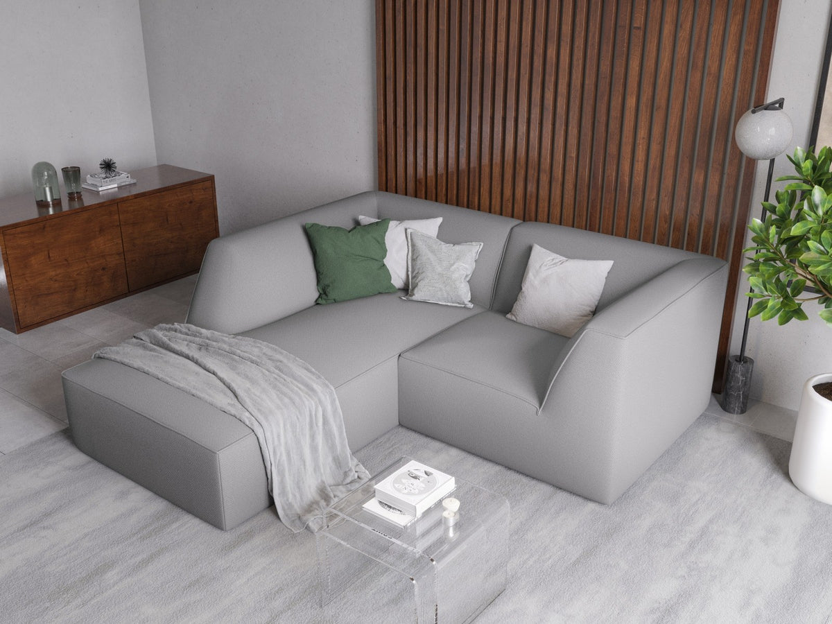 Modulares Ecksofa Siena mit gelbem Ottawa-Stoffbezug, schwarzen Kunststoffbeinen und Récamiere, Ansicht von vorne im Wohnraum.