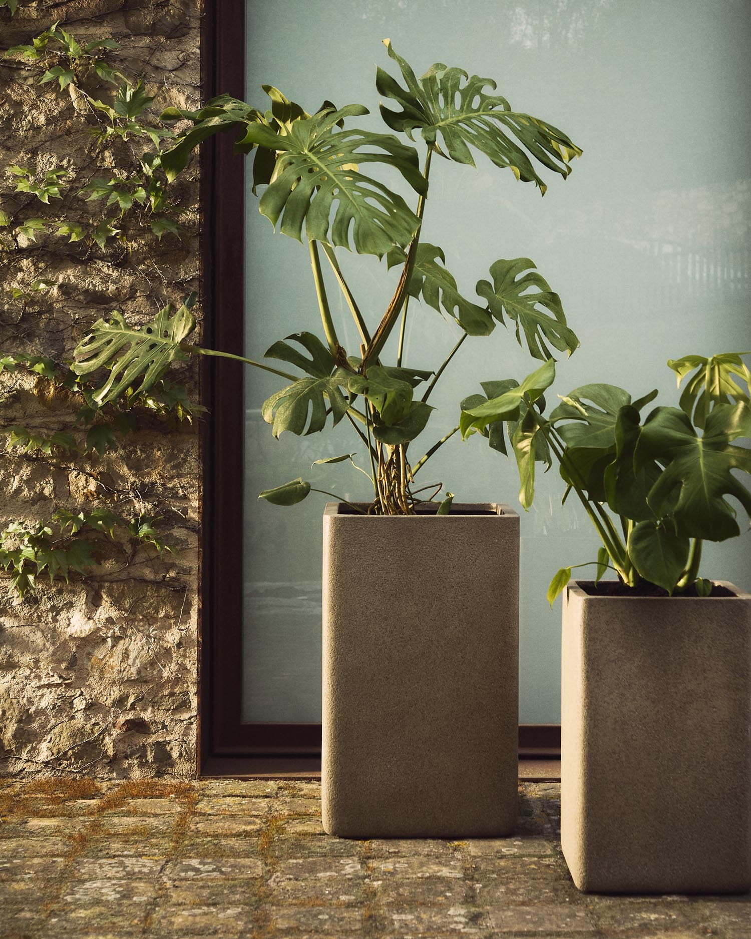 Entdecken Sie das elegante Set aus 2 hohen Blumentöpfen Minoa in senffarbenem Steinlook. Ideal für drinnen und draußen, verleiht es jedem Raum Stil.