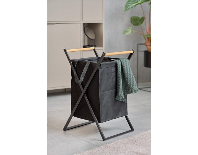Schwarzer Wäschesammler von ZELLER PRESENT mit stabilem Metallgestell, Polyester-Wäschesack und hölzernen Handgriffen im Wohnraum.