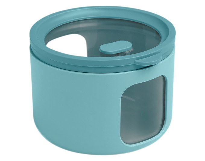 Runde teal-grüne Vorratsdose Tondo XS von BLIMPLUS mit transparentem Deckel und seitlichen Fenstern, Durchmesser 10 cm, Höhe 7.5 cm.
