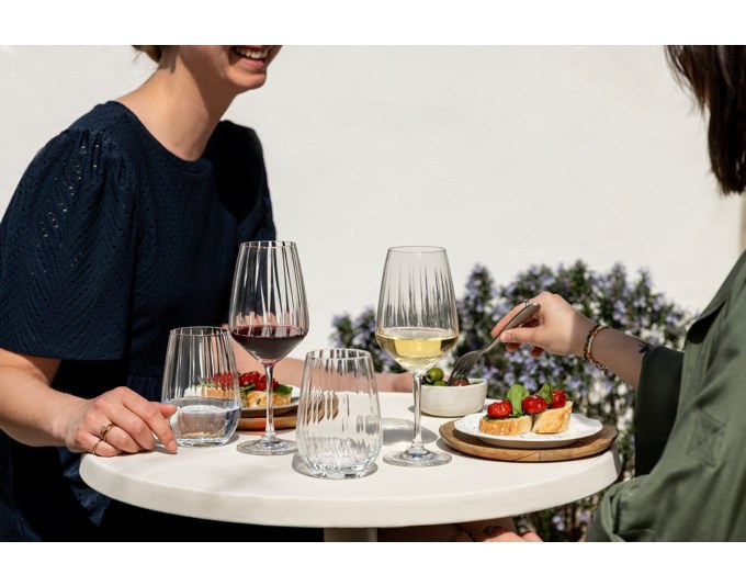 Vier transparente SCHOTT ZWIESEL Trinkgläser Blossom aus Tritan Kristallglas mit blütenartig geöffneter Kelchform und strukturierter Oberfläche.