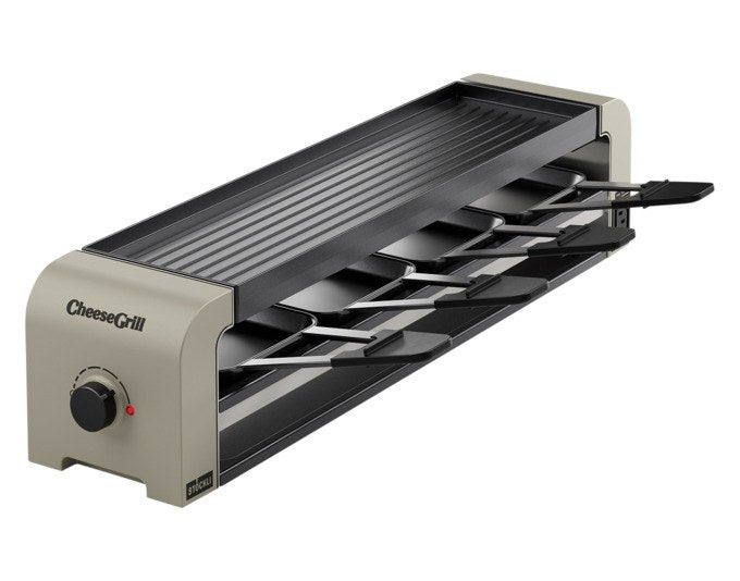 Tischgrill STÖCKLI CheeseGrill 4 Connect in Ivory Gold mit wendbarer Aluguss-Grillplatte, vier Pfännchen und Kunststoffspachteln.