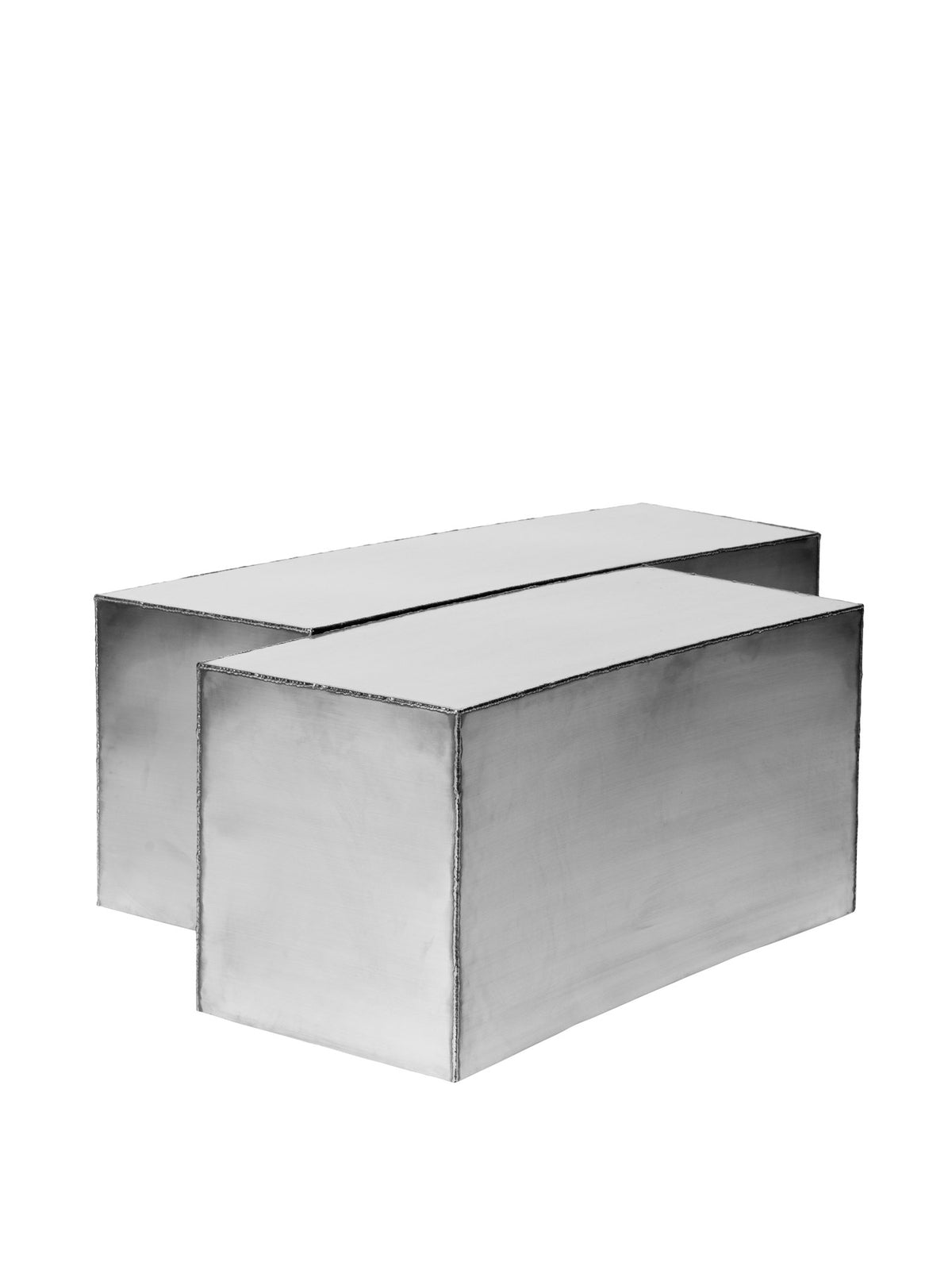 Ferra Couchtisch von Ferm Living aus gebürstetem Edelstahl mit sichtbaren, handverschweissten Kanten und leicht geschwungener Form.