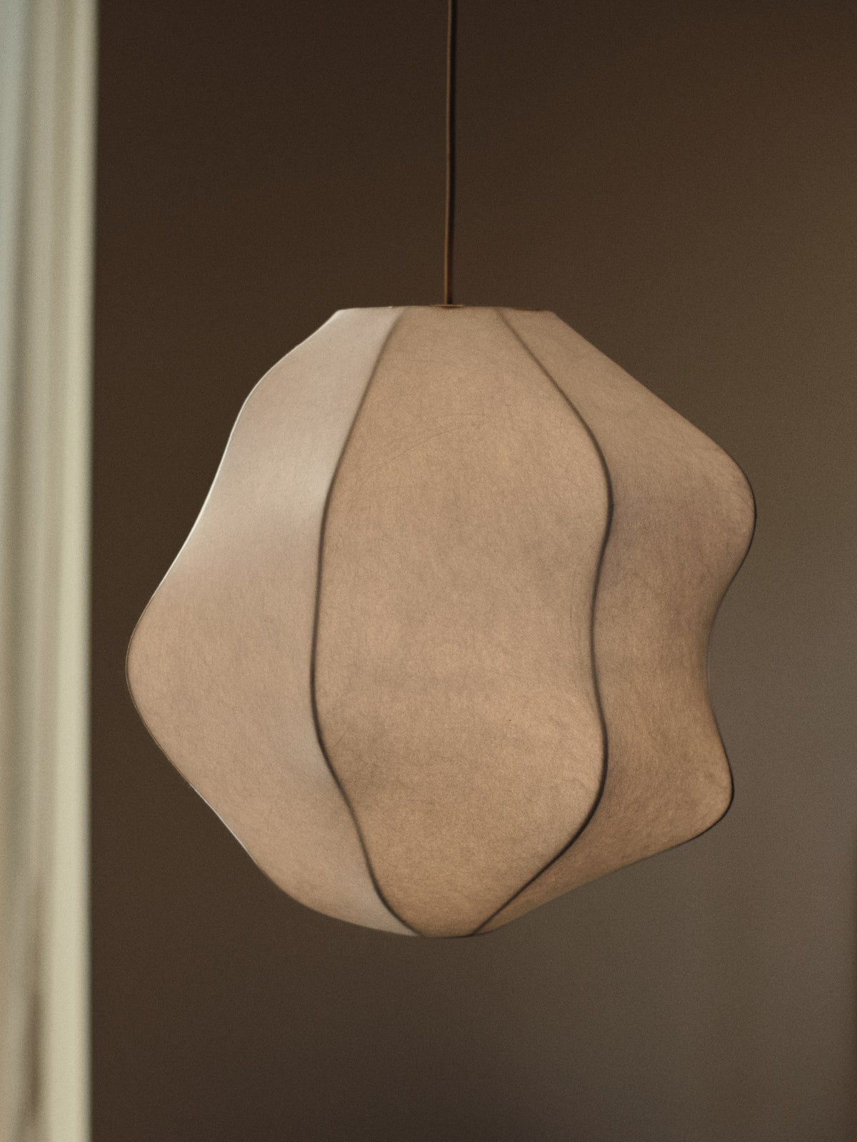 Weisser Lampenschirm Dae von Ferm Living aus pulverbeschichtetem Eisen mit organischer, kokonartiger Form und lichtdurchlässiger Oberfläche.