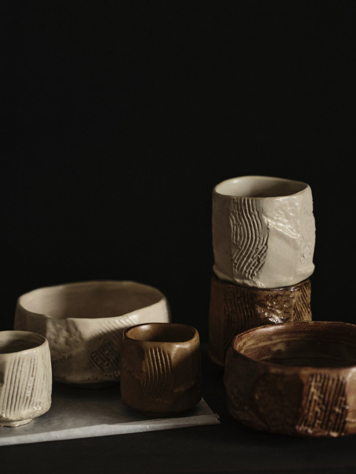 Kleine runde Keramikschale in Creme mit glasierter, unebener Oberfläche und organischer Form, handgefertigt aus Steinzeug.