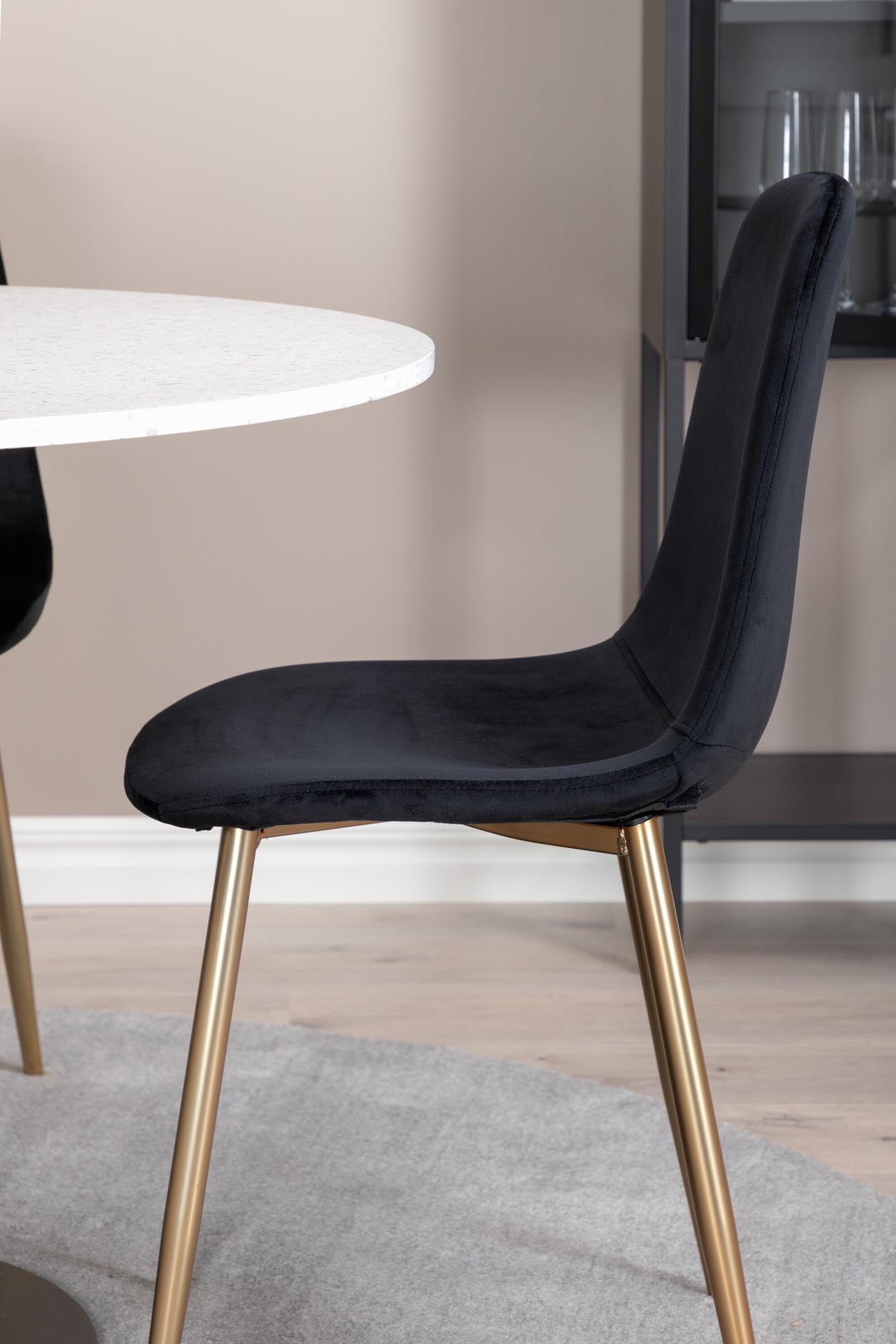 Entdecken Sie das elegante Razzia Esszimmerset von Venture Home: runder Tisch mit pflegeleichter Marmorplatte und bequemen Samtstühlen für stilvolle Esszimmer.