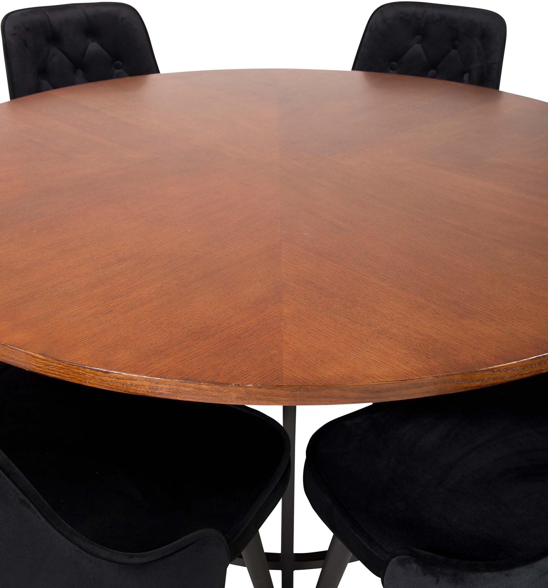 Stilvolles Esszimmerset mit runden Tisch und luxuriösen Samtstühlen für gesellige Abende und unvergessliche Momente.