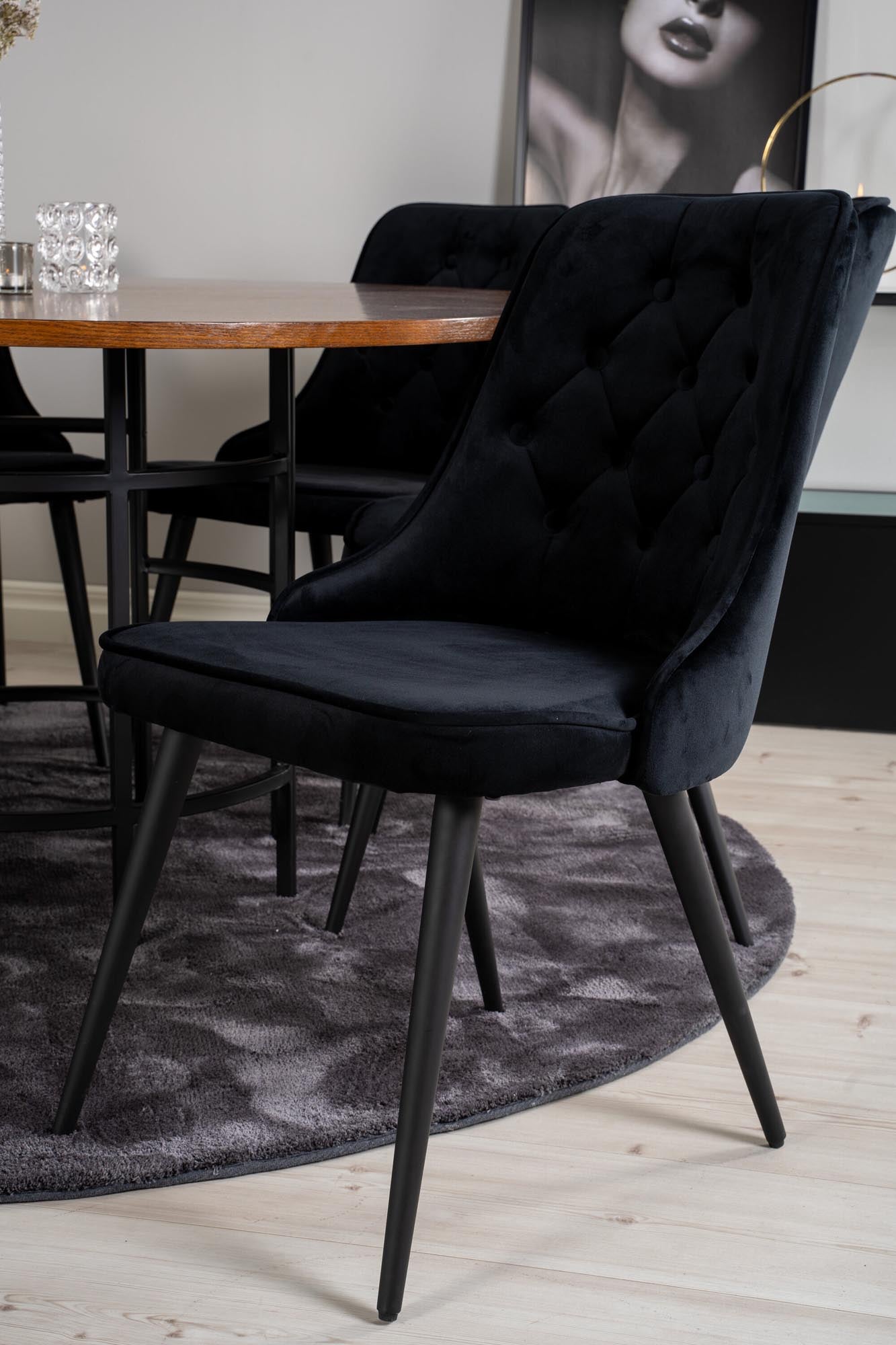 Elegantes Esszimmerset mit rundem Tisch und luxuriösen Samtstühlen. Perfekt für gesellige Anlässe und stilvolle Wohnräume.