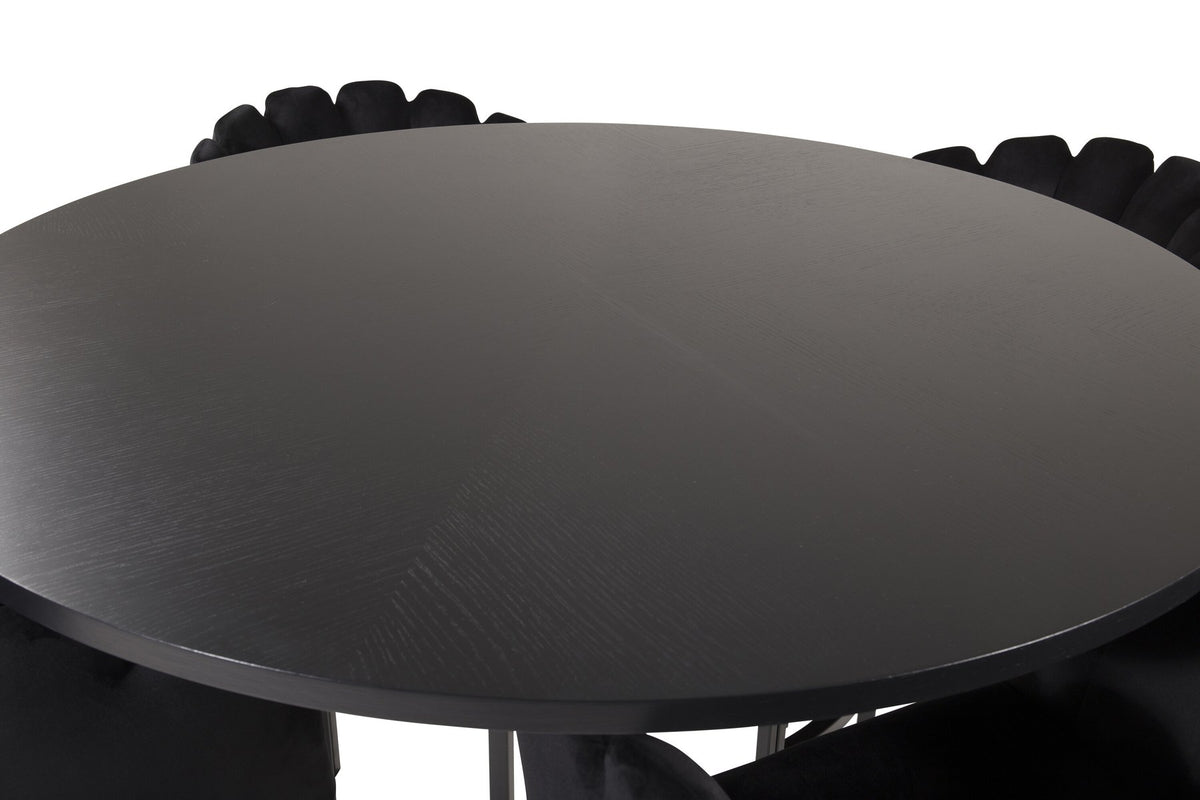Schwarzer Esszimmerstuhl aus der Limhamn-Serie mit Metallgestell neben rundem Esstisch Copenhagen aus MDF mit Furnier, Durchmesser 140 cm.