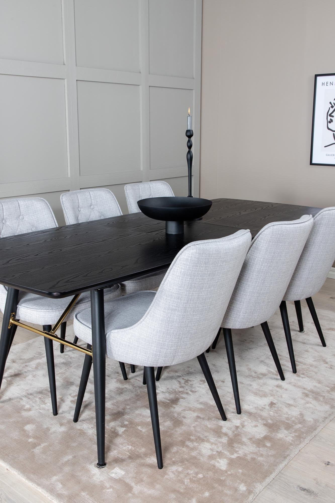 Elegantes Esszimmerset mit goldfarbenem, ausziehbarem Tisch und stilvollen Velvet-Stühlen für unvergessliche Dinner und gemütliche Abende.