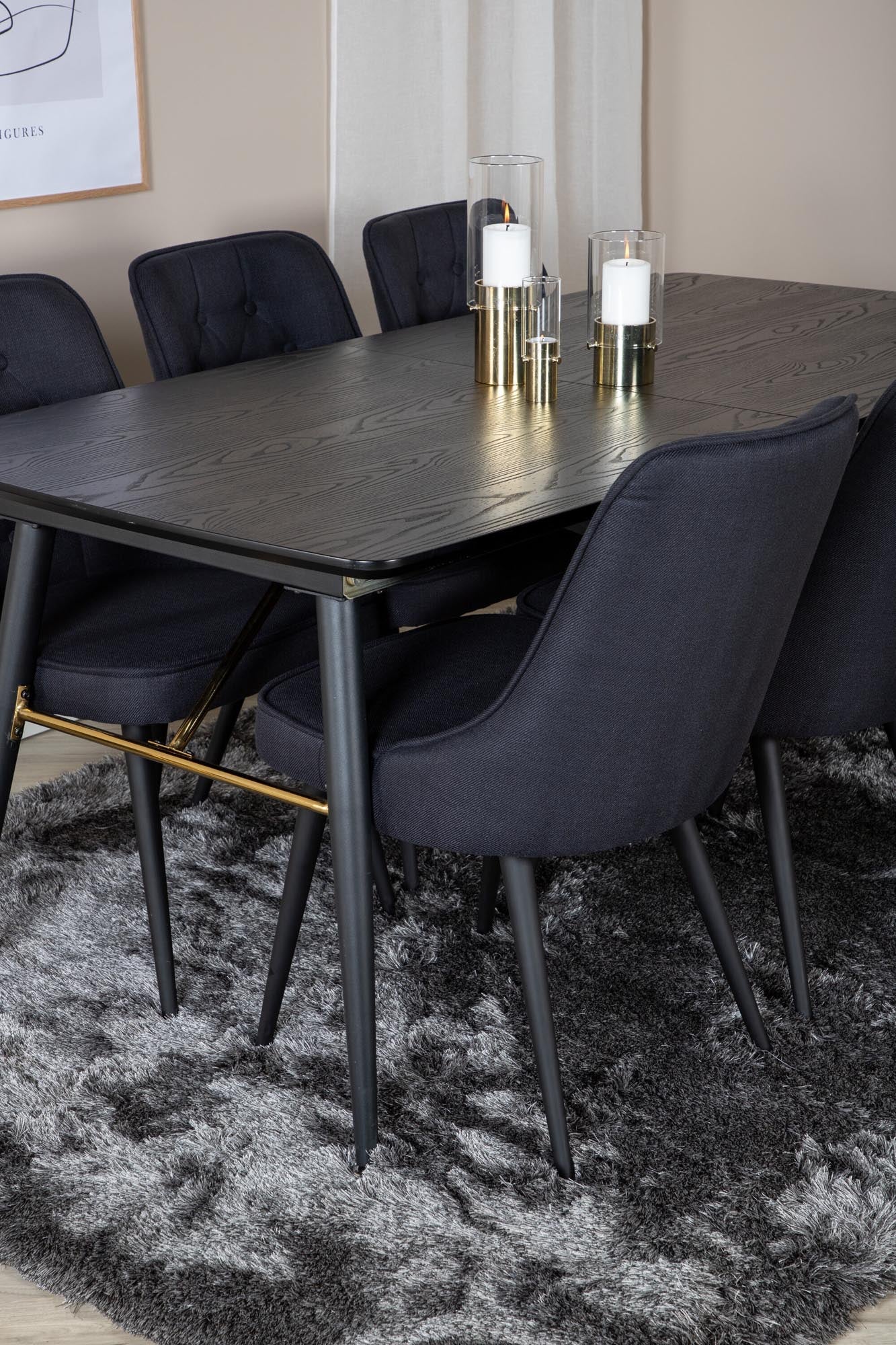 Luxuriöses Esszimmerset mit ausziehbarem Tisch und Samtstühlen.