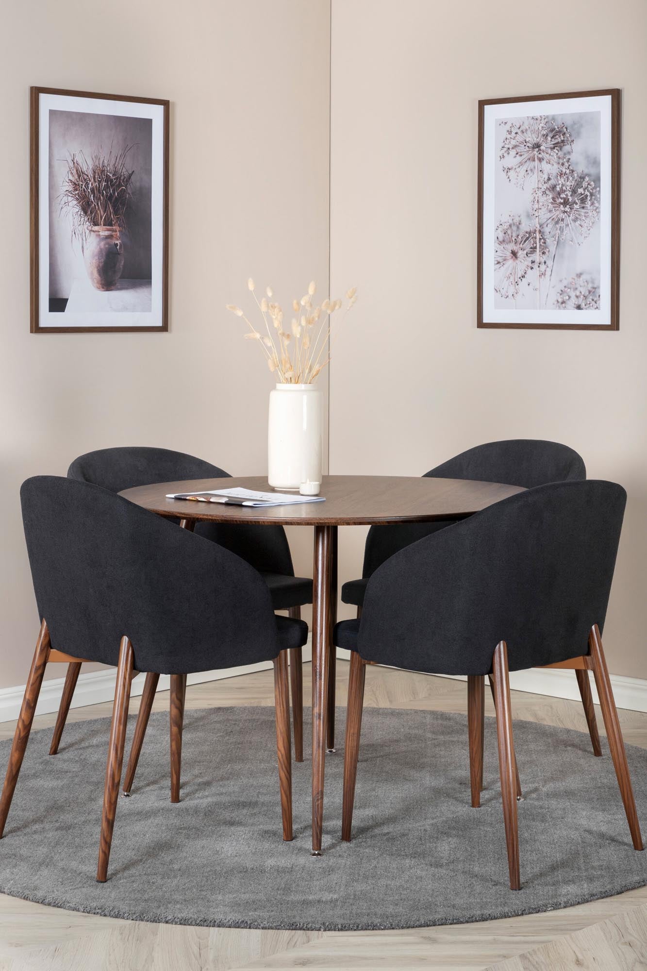 Erleben Sie das Plaza Esszimmerset + Arch von Venture Home: eleganter runder Tisch und bequeme Stühle für gesellige Momente in jedem Raum.