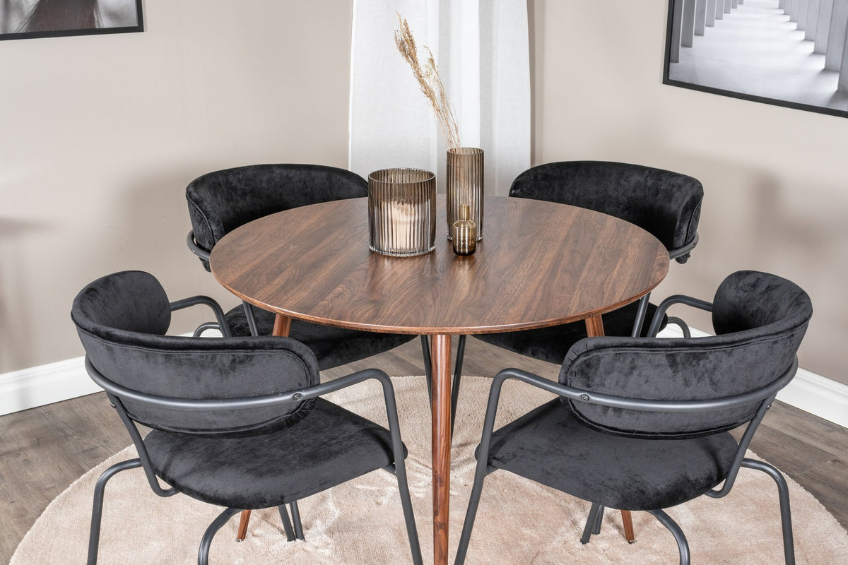 Rundes Esszimmerset zeigt Holztisch mit Nussbaum-Platte ⌀100 cm und zwei schwarze Stühle aus MDF und Stahl mit Samtbezug.