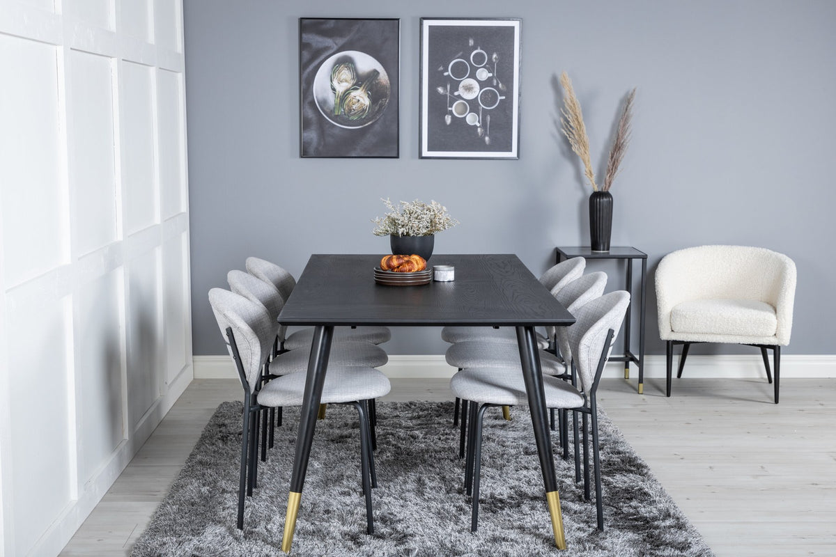 Schwarzes Esszimmerset Dipp mit Vault Stühlen: Tisch mit MDF-Furnierplatte und Stahlbeinen, Stühle mit Polsterbezug und Stahlgestell.