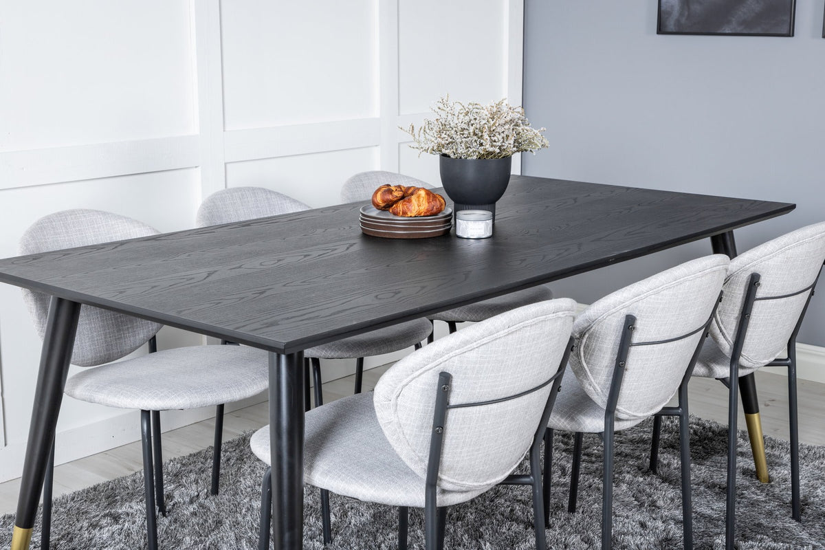 Schwarzes Esszimmerset Dipp mit Vault Stühlen: Tisch mit MDF-Furnierplatte und Stahlbeinen, Stühle mit Polsterbezug und Stahlgestell.