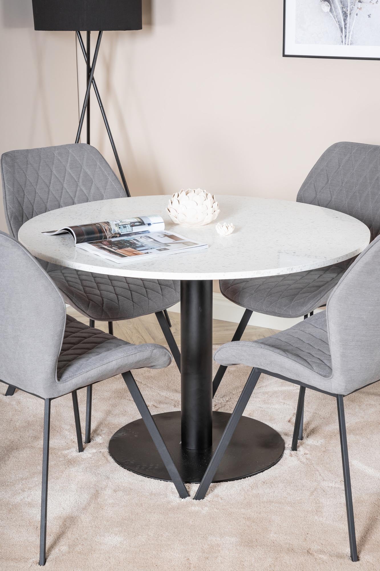 Elegantes Razzia Esszimmerset mit rundem Tisch (⌀106cm) und 4 bequemen Gemma-Stühlen. Ideal für gesellige Runden und stilvolle Anlässe.