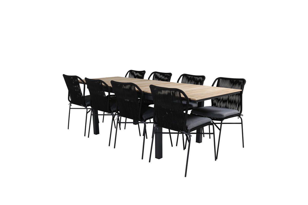 Vier schwarze Esszimmerstühle aus Aluminium mit Seilbezug und ausziehbarer rechteckiger Teakholz-Esstisch mit Stahlbeinen, Naturfarben.