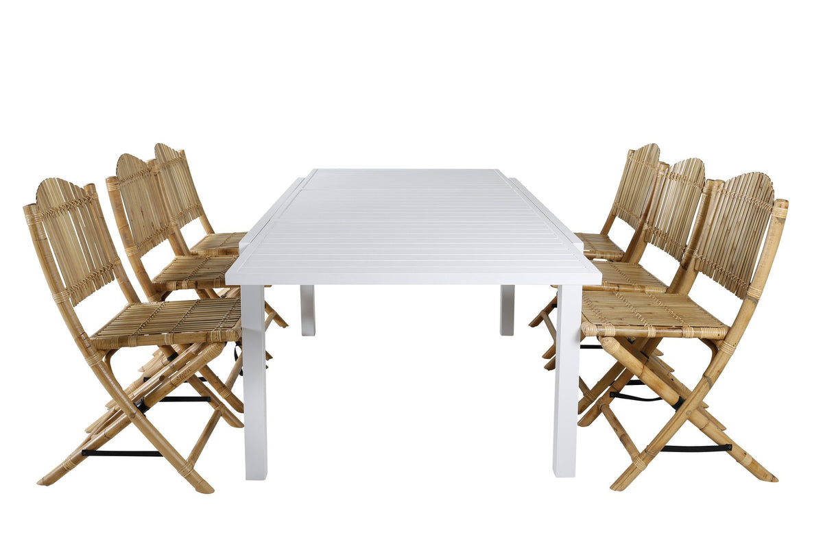 Aluminium-Caféstuhl in Natur mit Baumwoll-Polyester-Bezug neben rechteckigem Esstisch mit weisser Aluminium-Tischplatte und Rattanbeinen.