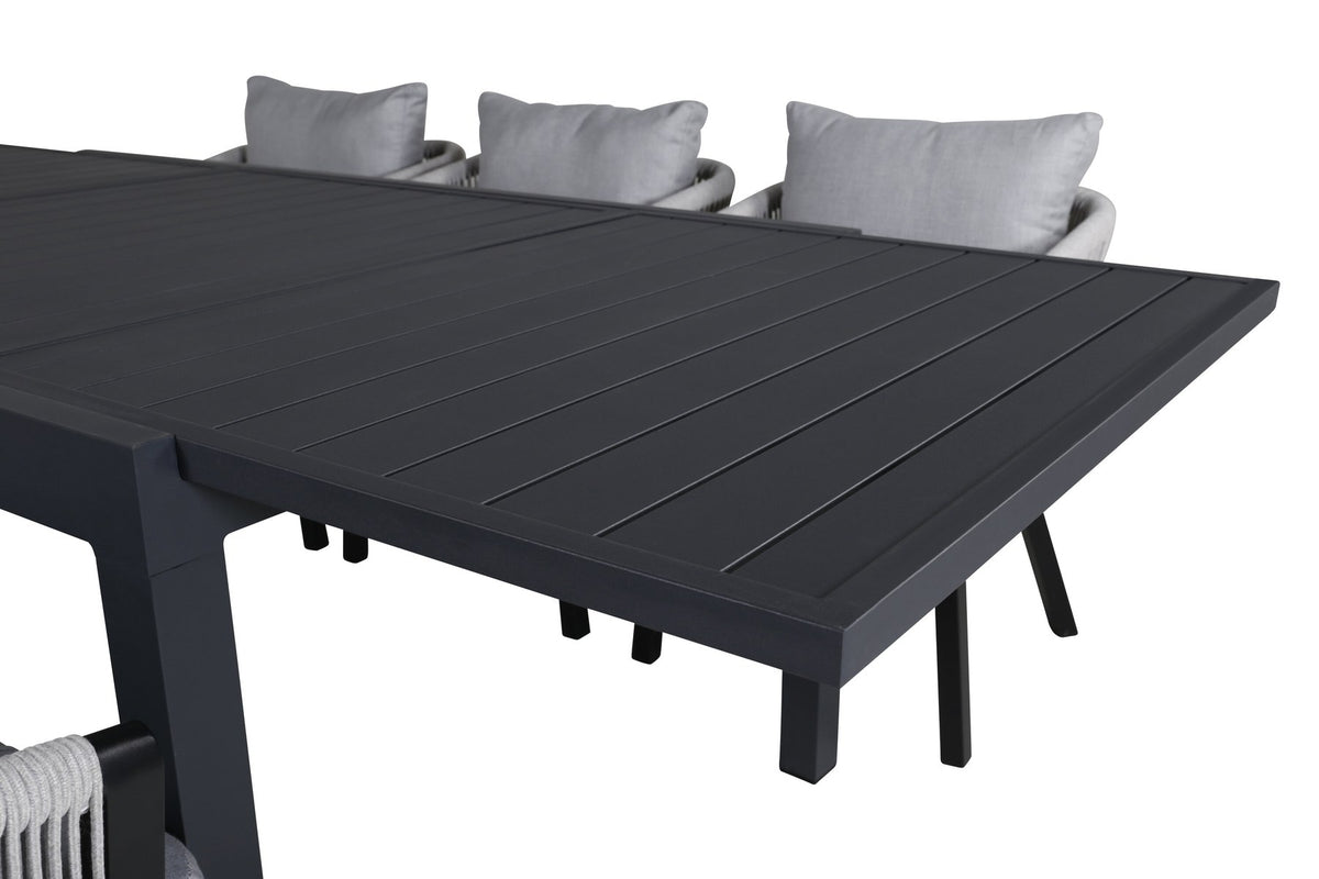 Gartentischset aus Aluminium: ausziehbarer Marbella Tisch mit schwarzem Gestell und 4 Virya Stühlen mit grauem Kissen im Aussenbereich.