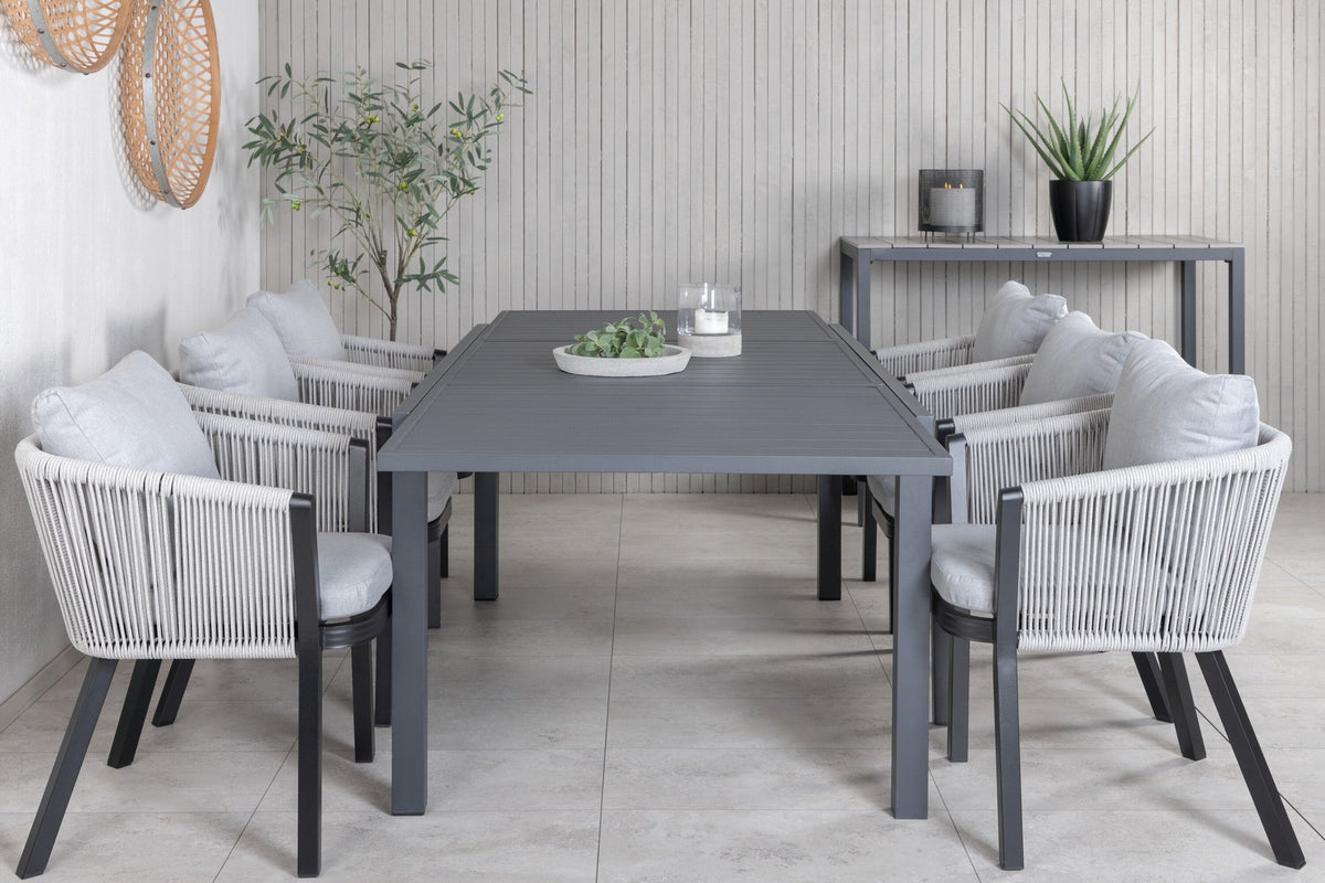 Gartentischset aus Aluminium: ausziehbarer Marbella Tisch mit schwarzem Gestell und 4 Virya Stühlen mit grauem Kissen im Aussenbereich.