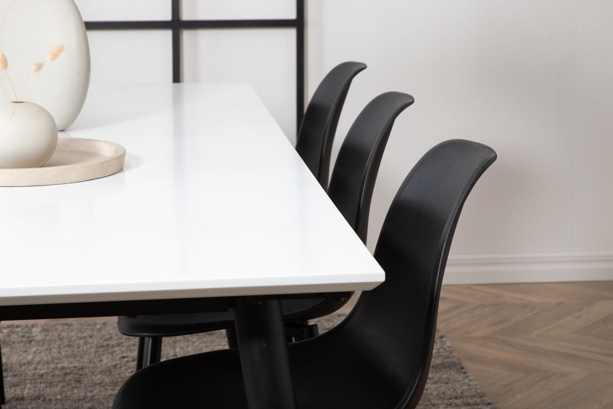 Esszimmerset Jimmy mit ausziehbarem Tisch aus weissem HPL und MDF, schwarzen Stahlbeinen sowie sechs schwarzen Polar-Stühlen mit Kunststoffsitz.