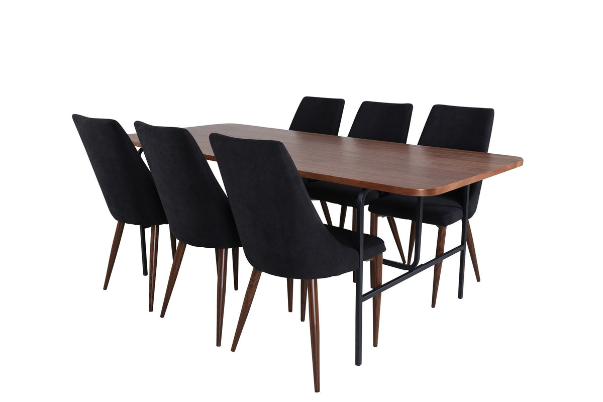 Rechteckiger Esstisch mit MDF-Tischplatte in Nussbaumfurnier und schwarzem Stahlgestell, kombiniert mit zwei schwarzen Polyester-Stühlen.