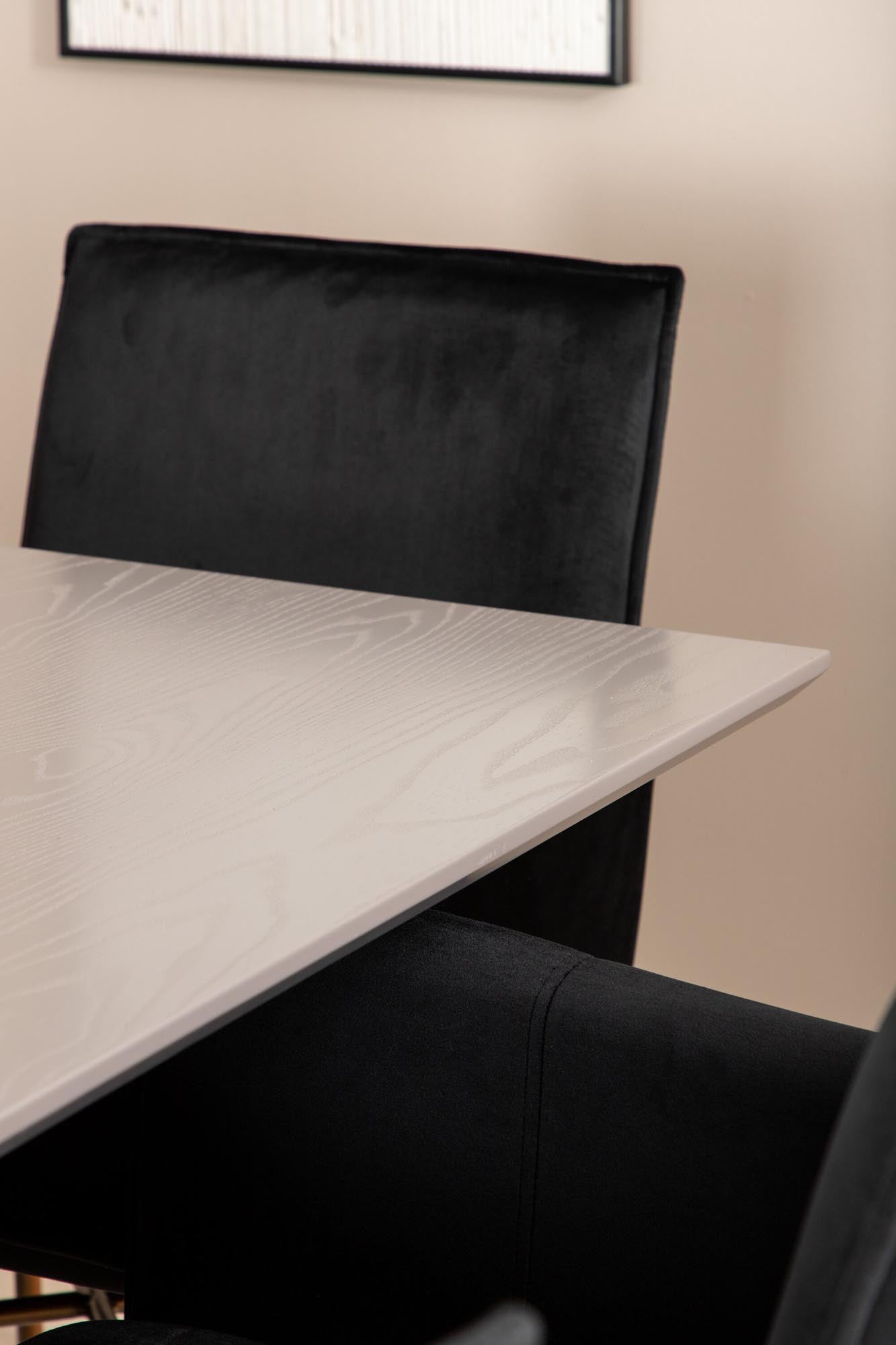 Elegantes Esszimmerset mit luxuriösem Tisch und bequemen Samtstühlen für gesellige Abende. Ideal für Ihr modernes Zuhause.