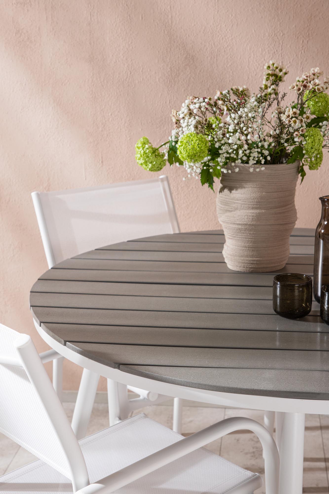 Stilvoller Break Esstisch mit 4 stapelbaren Santorini Armstühlen.