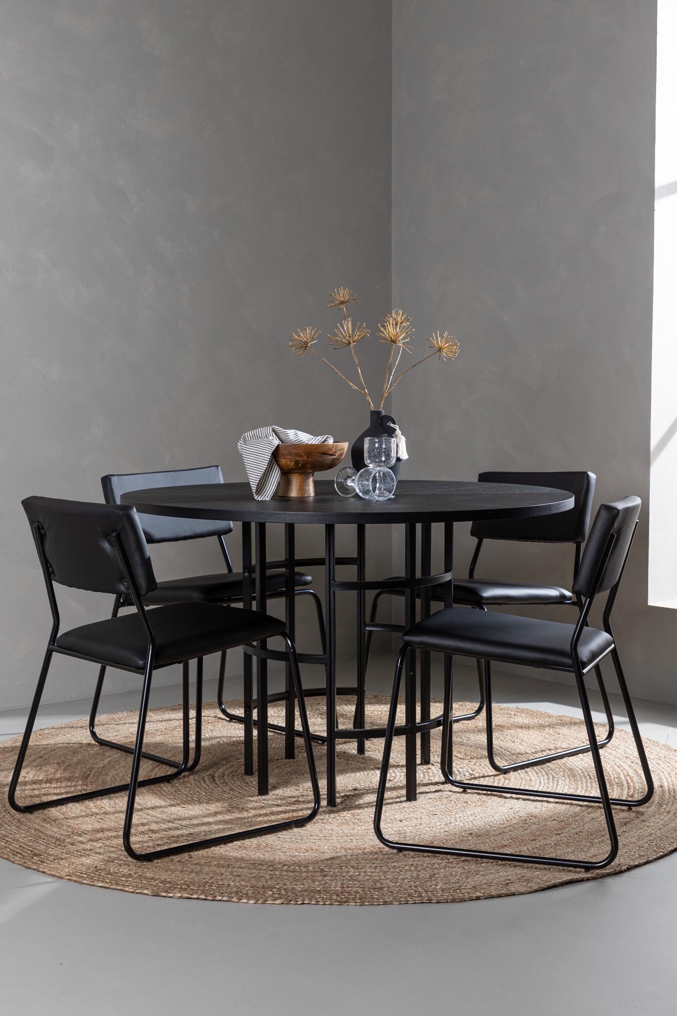 Modernes Esszimmerset mit elegantem runden Tisch und komfortablen Stühlen für stilvolle Mahlzeiten in kleinen bis mittelgroßen Räumen.