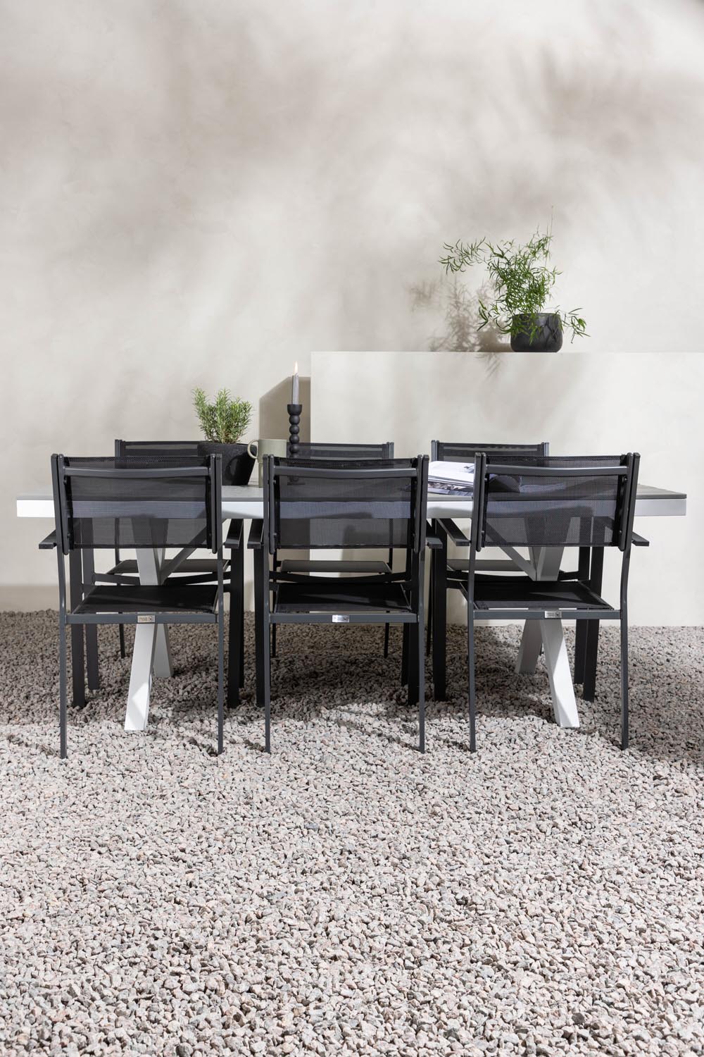 Rechteckiger Gartentisch Garcia mit Aluminiumgestell und Aintwood-Platte, umgeben von sechs stapelbaren Copacabana-Stühlen mit Textilene-Sitzfläche.