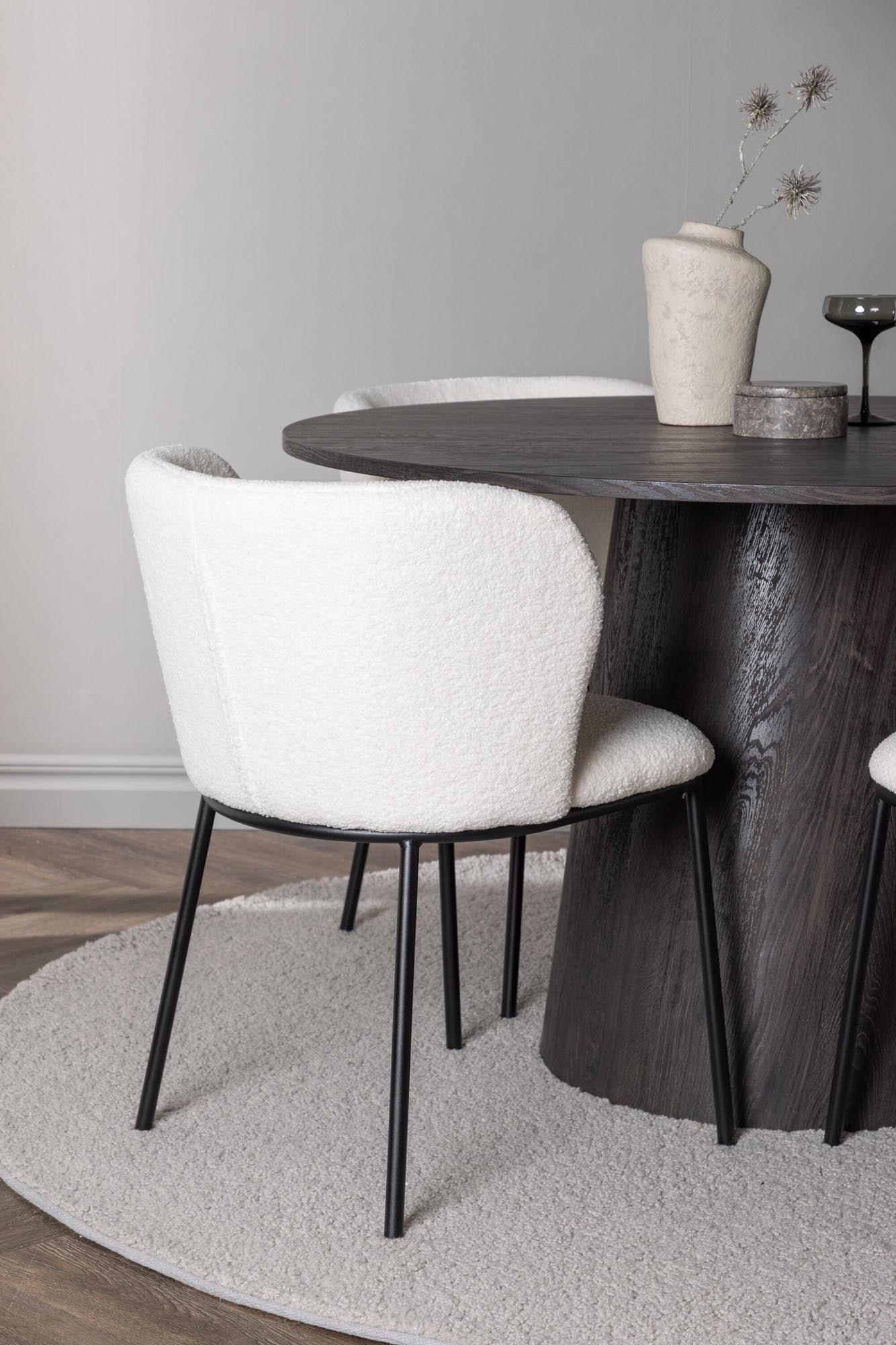 Entdecke das Lanzo Esszimmerset + Edina von Venture Home: runder Tisch aus robustem MDF, stilvolle Stühle aus Bouclé-Stoff, ideal für gesellige Runden.